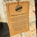 Kraft paper tag with 'Original Handmade Product' text on a stone background