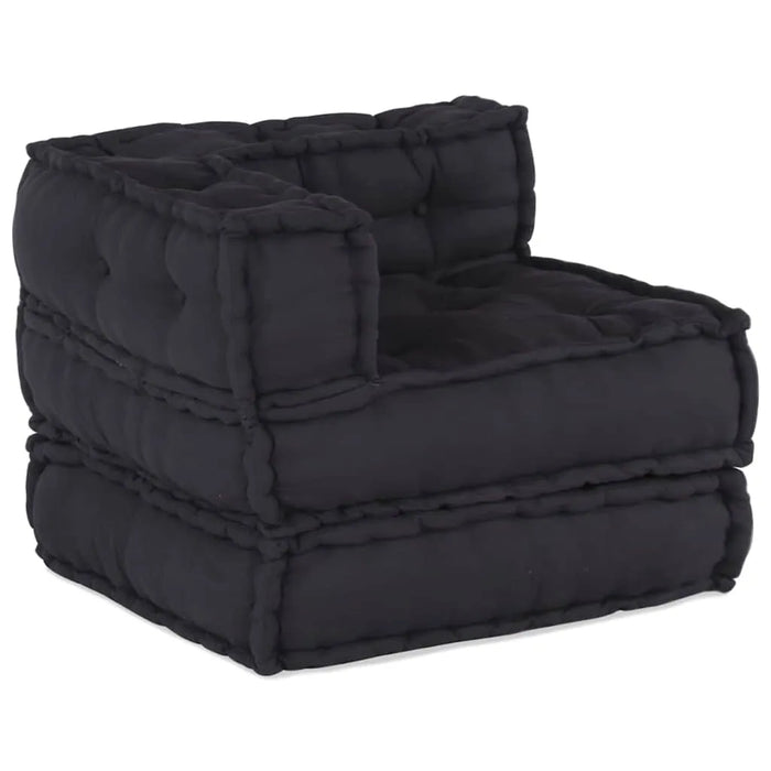 Black quilted ottoman on a white background