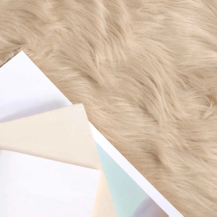 Close-up of light brown fur texture with a white card and beige paper underneath.