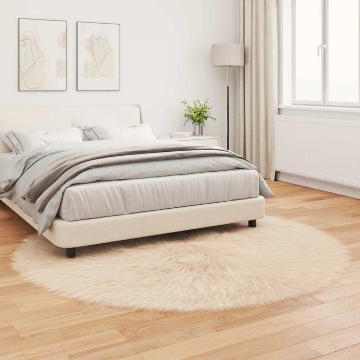 Neatly made bed in a bedroom with light wood flooring and white walls.