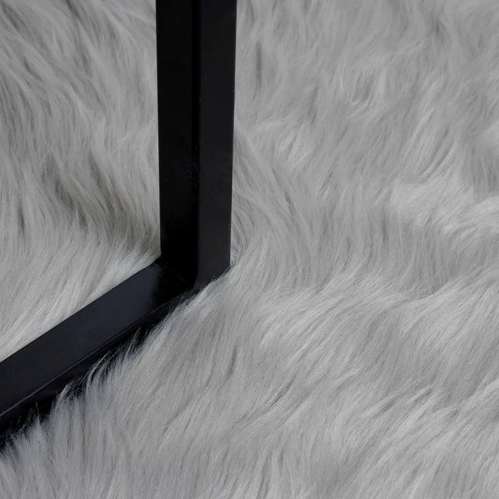 Close-up of a black rectangular object on a gray fur-like surface
