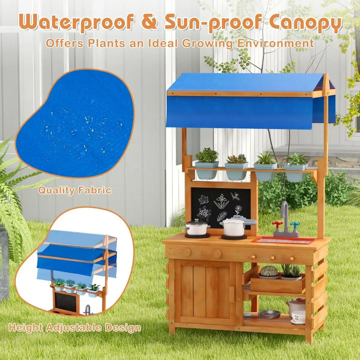 Wooden play kitchen with blue adjustable canopy outdoors, featuring toy pots, sink, and plant pots