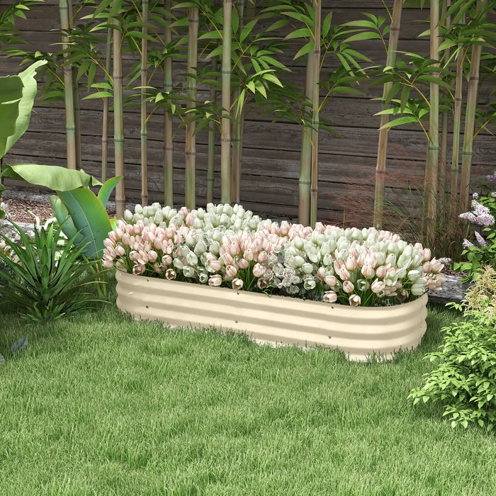 Cream flexible raised garden bed planter with white and pink tulips in a backyard with bamboo and green grass
