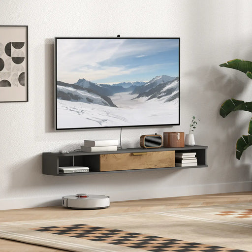Modern living room with floating black and wood TV cabinet, wall-mounted TV, decorative items, and robot vacuum on wooden floor