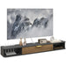 Modern floating TV cabinet in black and wood finish with cable management, decorative figurines, clock, and radio
