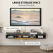 Floating black and wood TV cabinet with flip-up door and two open compartments for storage and cable management