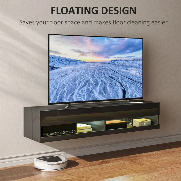 Black floating TV stand with LED lights and glass doors, holding a large flat screen TV showing a snowy landscape