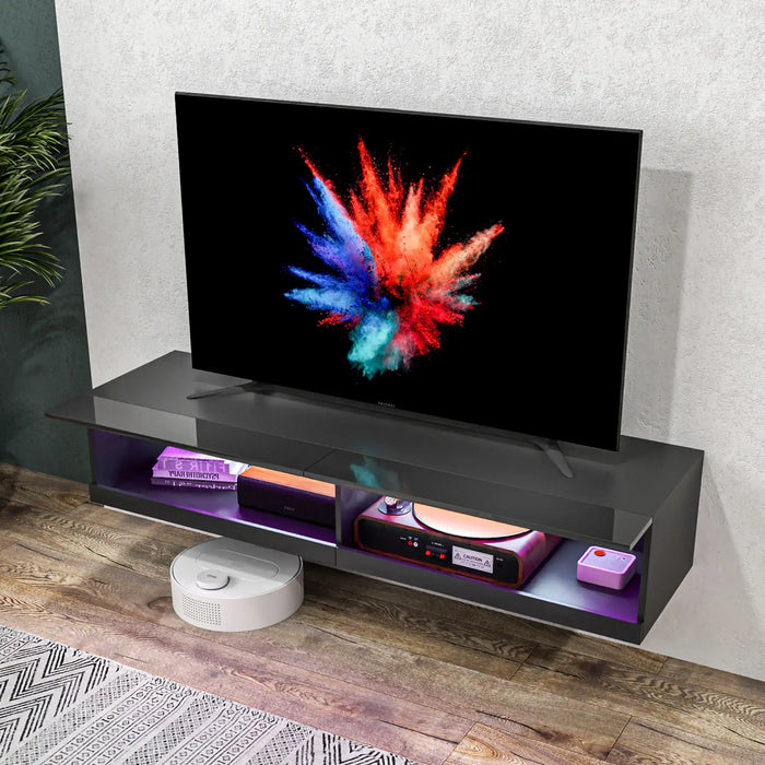 Floating black TV stand with LED purple lighting, holding a flat screen TV and electronic devices in modern living room