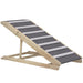 Adjustable wooden pet ramp with gray carpeted surface and white fabric strips for traction