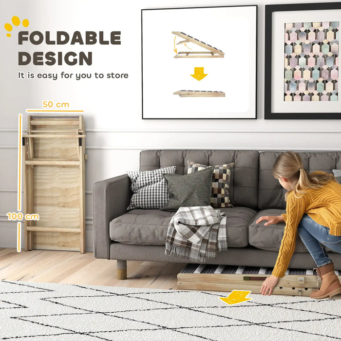 Foldable wooden rack stored beside gray sofa with cushions in modern living room, demonstrating space-saving design