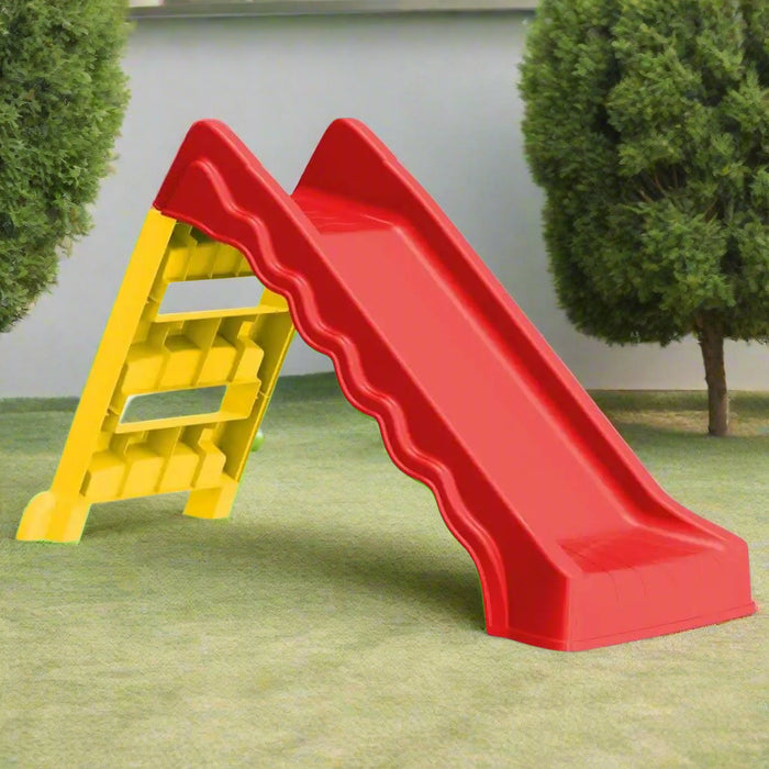 Red and yellow foldable kids slide for indoor and outdoor use on grass lawn