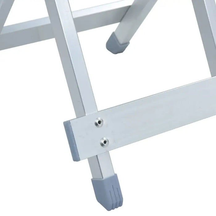 Close-up of folding aluminium camp stool legs with silver finish and grey rubber feet