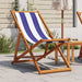 Blue and white striped folding beach chair with solid wood eucalyptus frame on patio