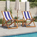 Blue and white striped folding beach chairs with wood frames by a poolside