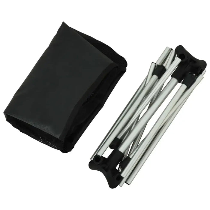 Folded lightweight aluminium camping chair and black carry bag on white background