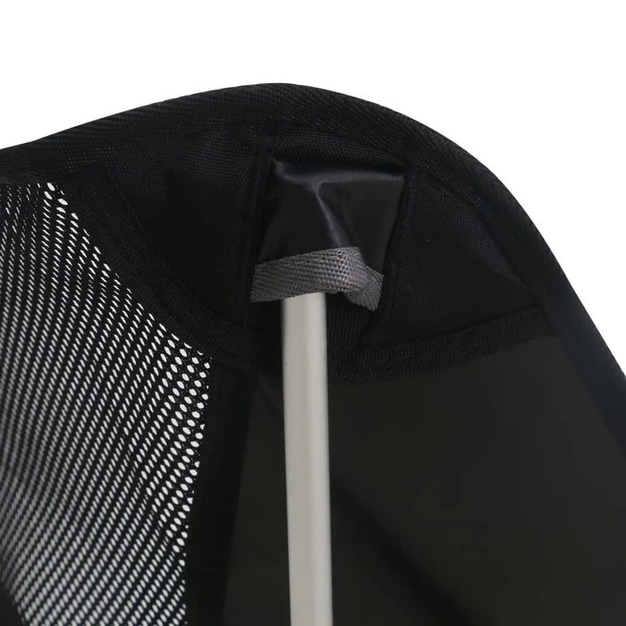 Close-up of black mesh and aluminum frame of folding camping chair