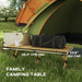 Folding camping table with natural wood effect, bag and kettle, set by tent outdoors