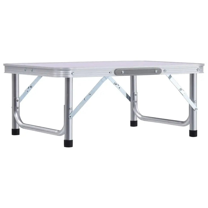 Lightweight folding aluminum camping table with white tabletop and black feet.
