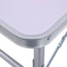Close-up of a white aluminum folding camping table corner with metal frame and legs