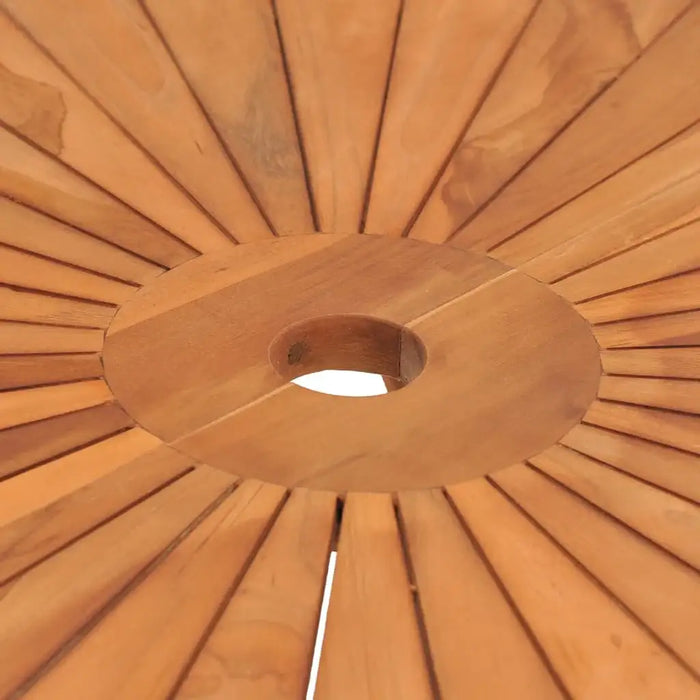 Close-up of solid teak garden table top with central umbrella hole and radial wood pattern