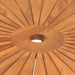 Close-up of solid teak garden table top with central umbrella hole and radial wood pattern