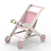 Folding wooden pink doll stroller with plywood frame and pastel wheels on white background