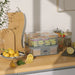 Food dehydrator on a kitchen counter with lemons and other items