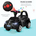 Black foot-to-floor ride-on car for toddlers with music, horn, and LED headlights