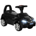 Black foot-to-floor ride-on car toy with flashing headlights and chrome wheels for toddlers
