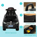 Black foot-to-floor ride-on car for toddlers with carrying handle, comfortable seat, and hidden storage.