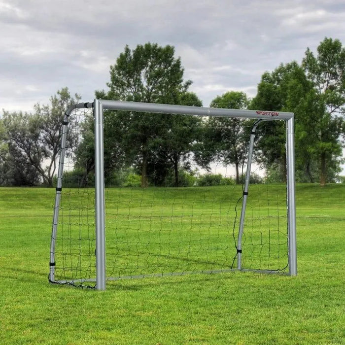 8ft x 5ft portable football goal net on green grass field with trees in background