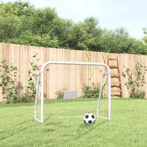 White steel football goal with net and soccer ball on grass in a backyard garden setting