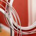 Close-up of white metal wires against a red background