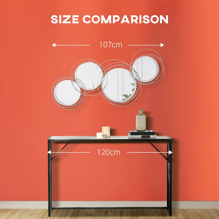 Size comparison of wall mirrors on an orange wall with a table and decorative items.