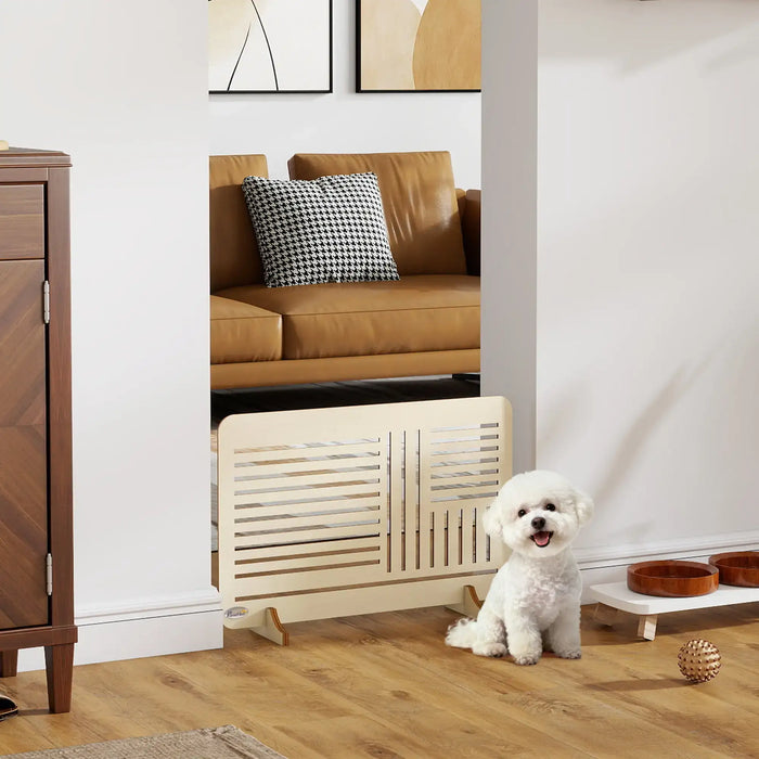 White dog sitting on a wooden floor in a living room with a radiator and furniture.