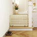 Beige radiator on a wooden platform with a plant and small bowl in a room.