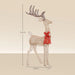 135cm tall glittery Christmas reindeer decoration with a large red bow on beige background