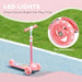 Pink kids' scooter with LED light-up wheels on outdoor pavement and grass background