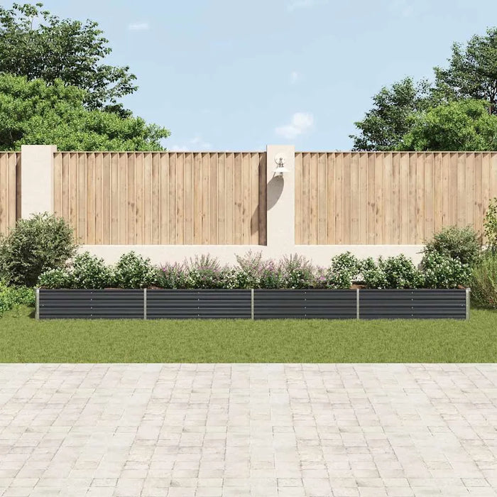 Anthracite galvanized steel raised garden bed planter with flowers against wooden fence and greenery