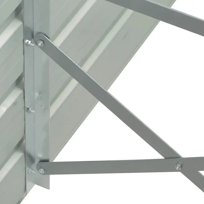 Close-up of galvanized steel corner bracket with bolts on raised garden bed frame