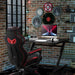 Black Z-shaped gaming desk with cable management, gaming chair, and brick wall decor