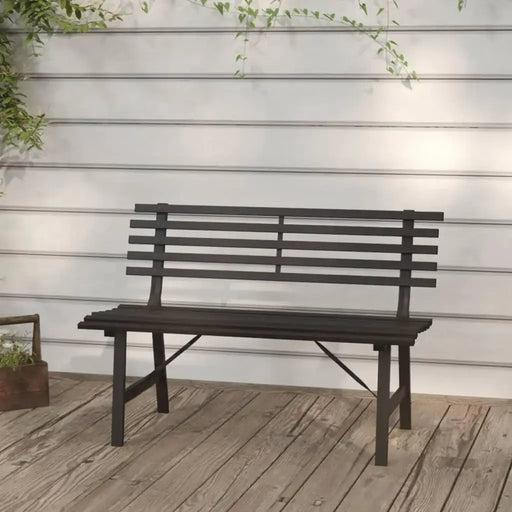 Black powder-coated steel garden bench with slatted backrest on wooden deck
