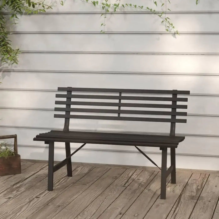 Black powder-coated steel garden bench with slatted backrest on wooden deck