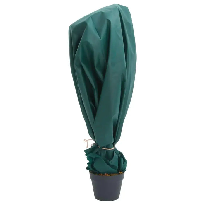Potted plant covered with green garden fleece roll for frost protection