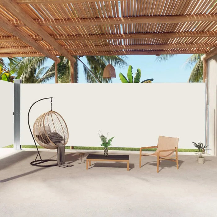 Outdoor patio with cream retractable side awning, loungers, and wooden pergola roof.