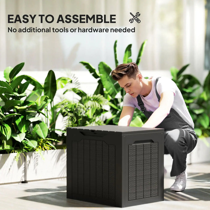Young man assembling black waterproof outdoor garden storage box in bright sunlit patio with green plants