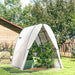 White garden arch with plants underneath in a backyard setting