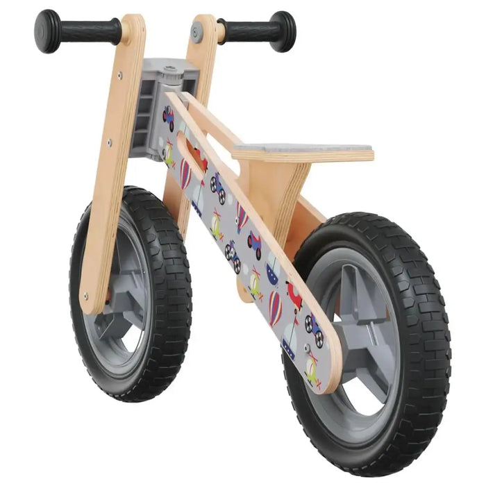 Grey and black balance bike with plywood frame, adjustable seat, and fun printed designs