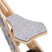 Close-up of grey felt seat on plywood balance bike with car pattern and black wheel