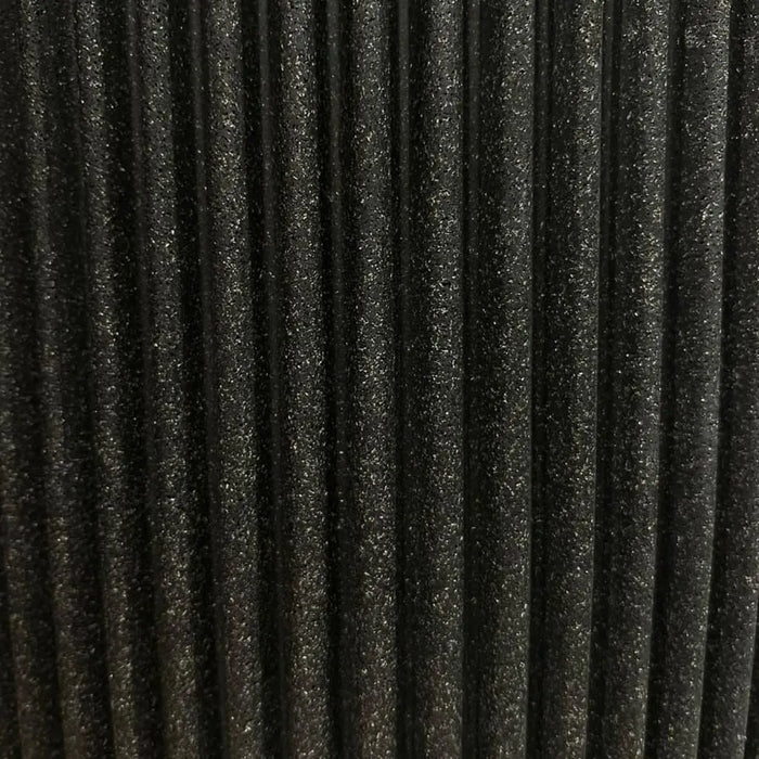 Close-up of black grooved planter made from recycled material with textured surface
